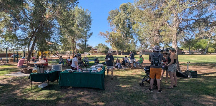 A photograph of a potluck brunch in Pinecrest Park.